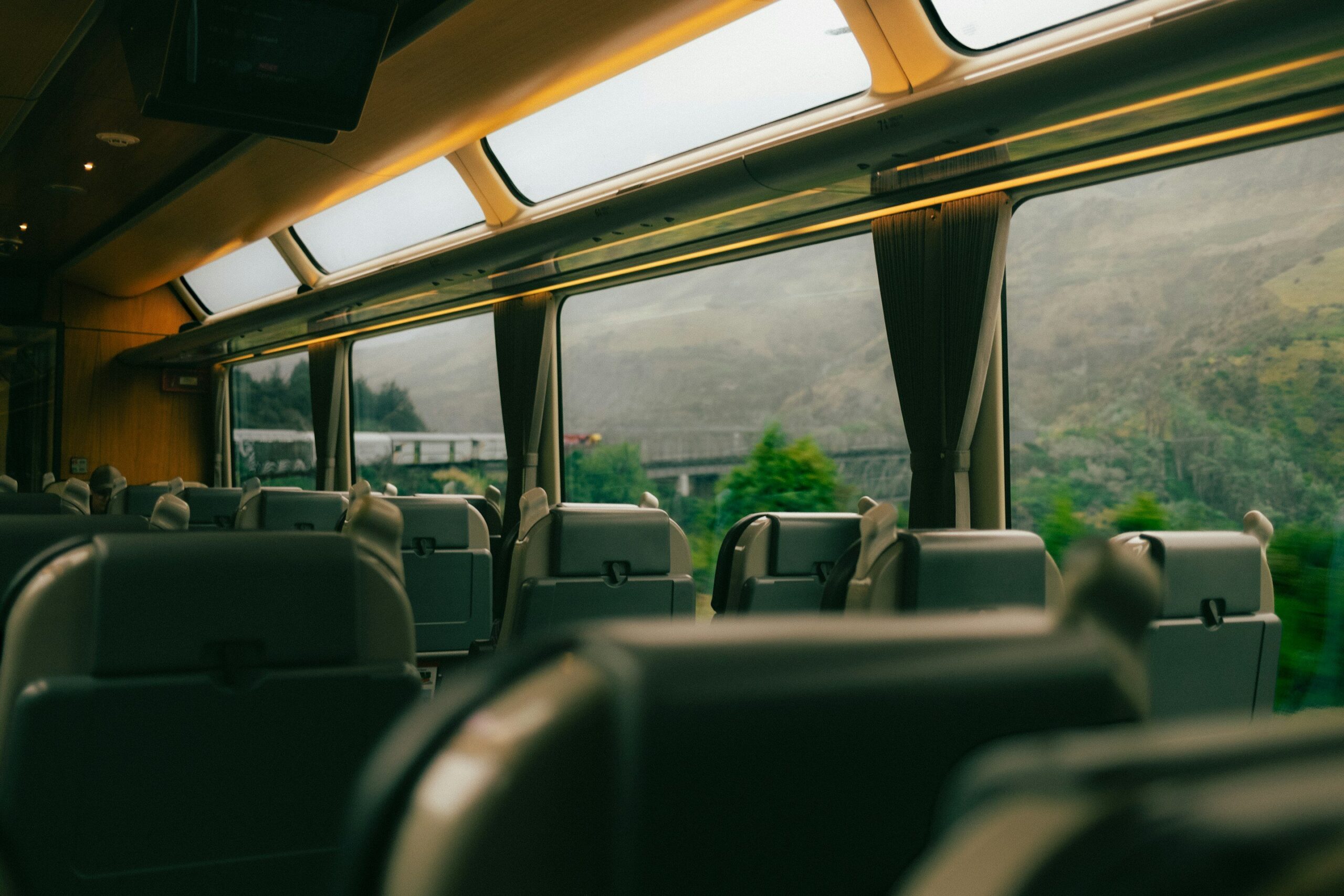 A train journey through open, scenic countryside