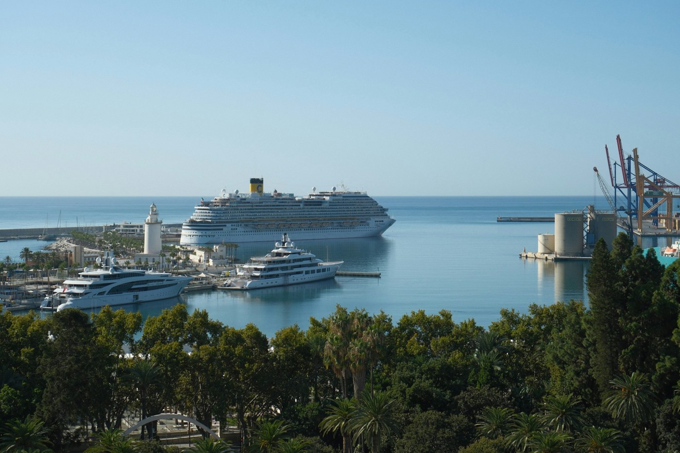 A cruise ship and yachts docked in the harbor of Málaga, Spain