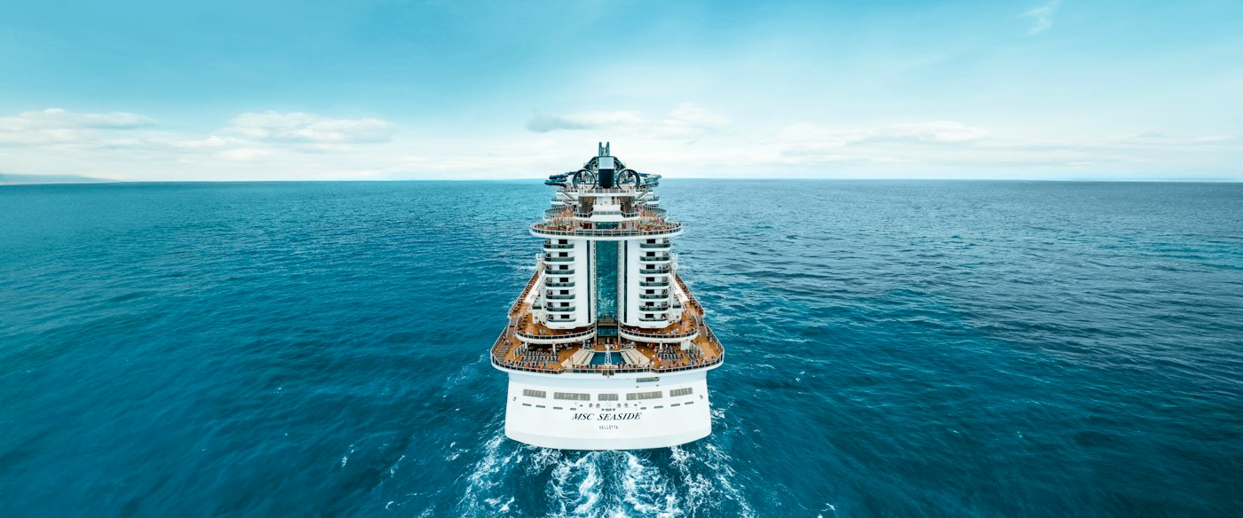Large cruise ship sailing on a calm blue ocean