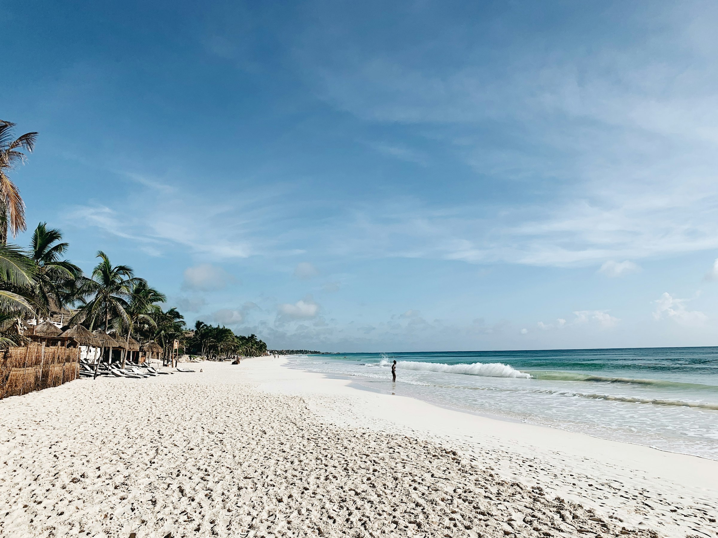Palm-lined white sand beach and turquoise water in Tulum, Mexico